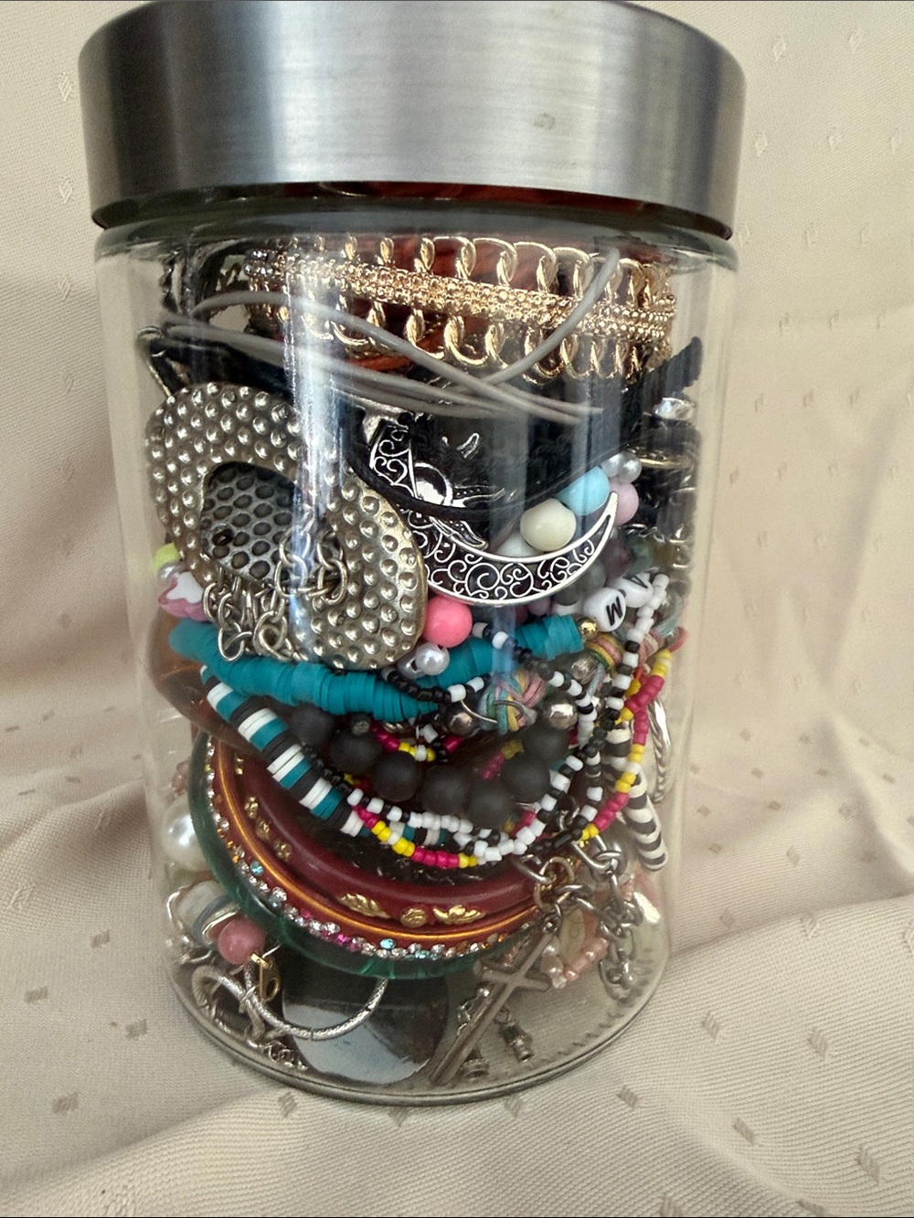 Mystery jar with Assorted Beaded and Metal Bracelets , earrings and necklaces.
